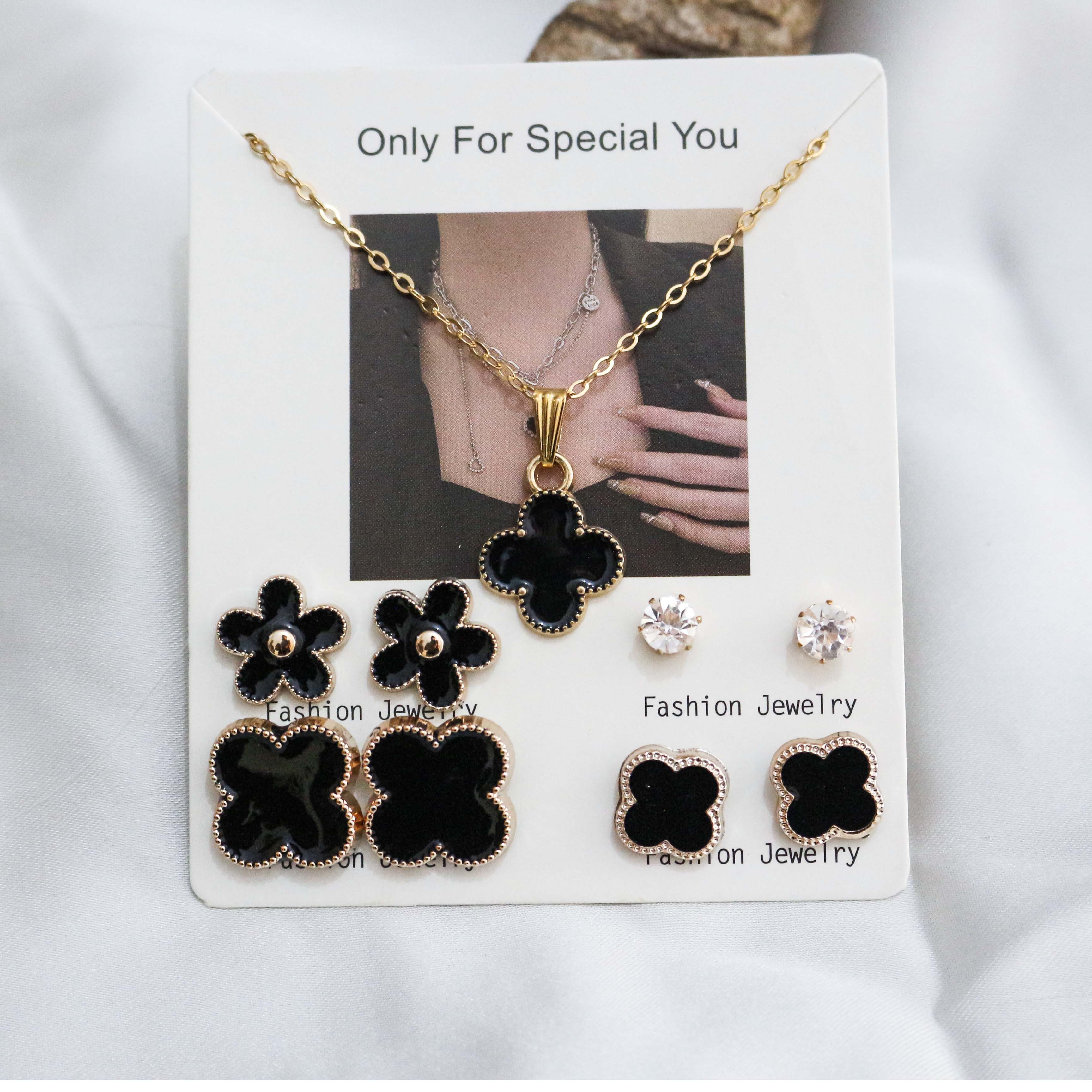 Jewelry set with black flower-shaped earrings and a necklace