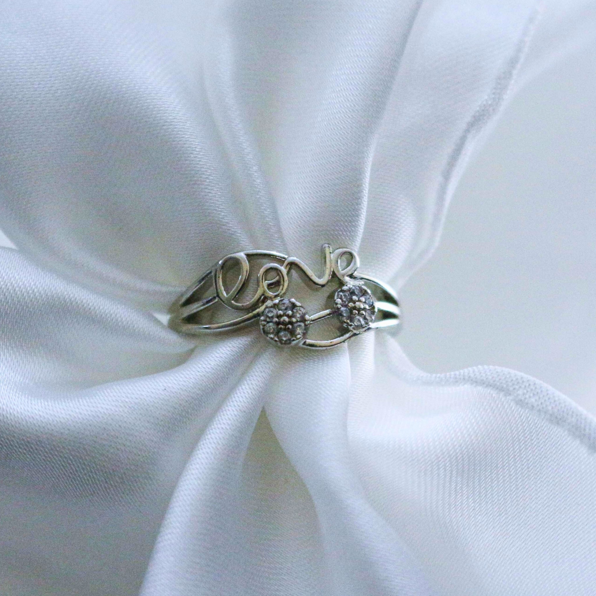 Silver ring with 'love' and heart design