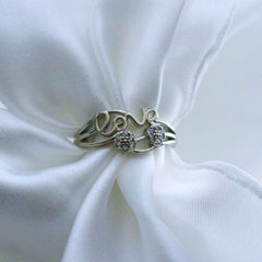 Silver ring with 'love' and heart design