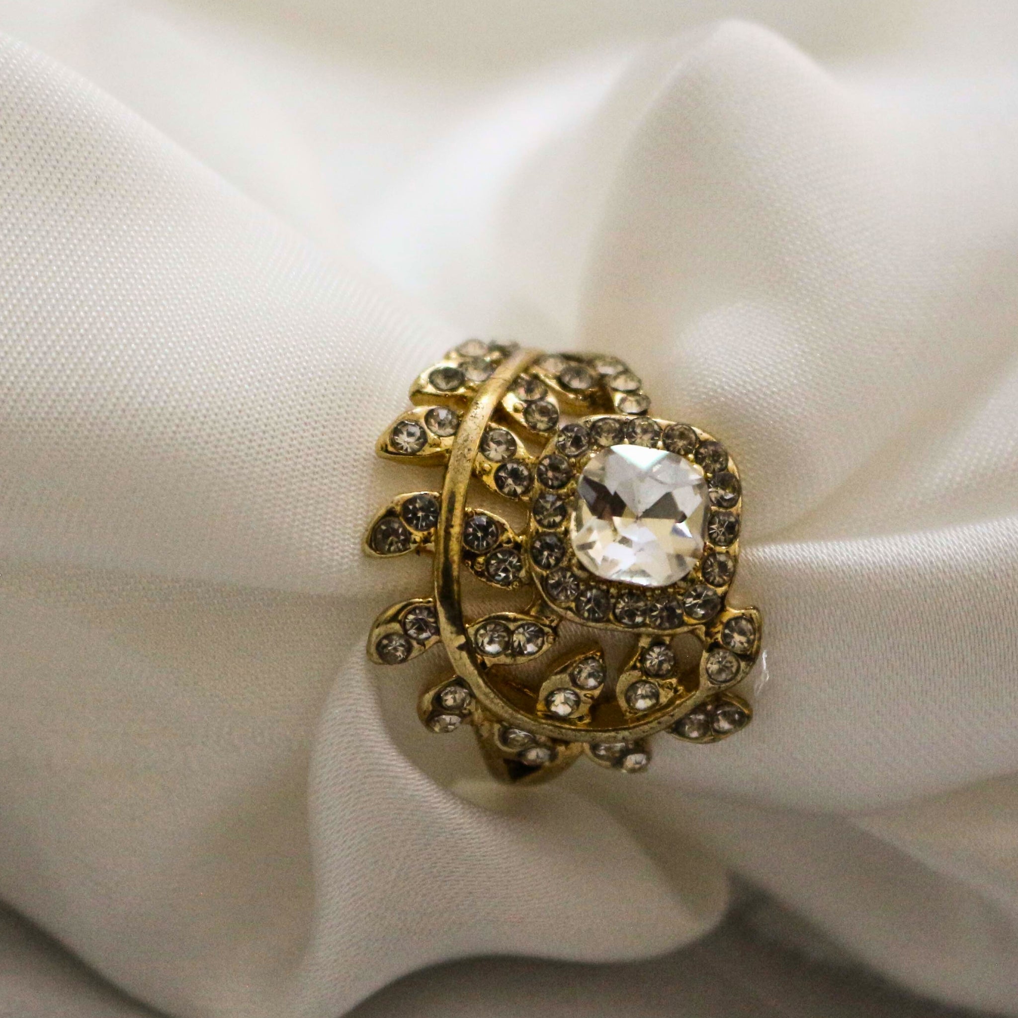 Golden ring with a large central gemstone