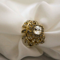 Golden ring with a large central gemstone